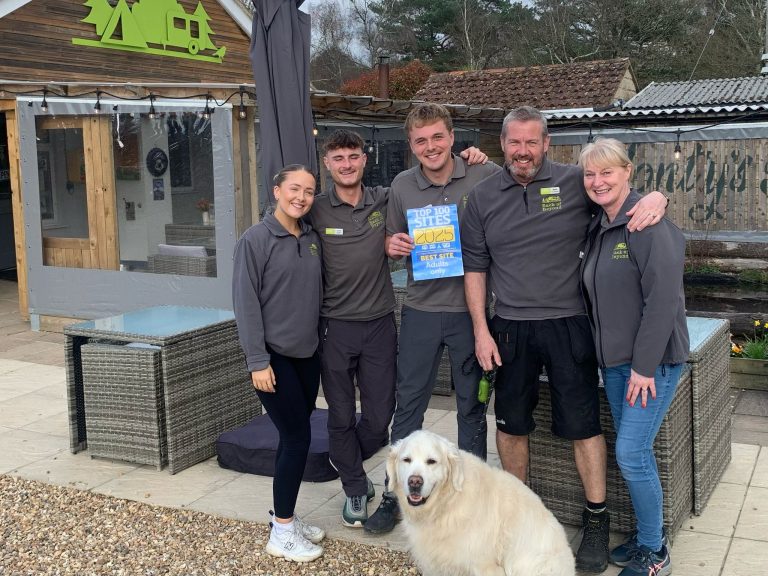 5 members of the Back of Beyond team stand with the Best Site for Adults award certificate from Practical Caravan magazine.