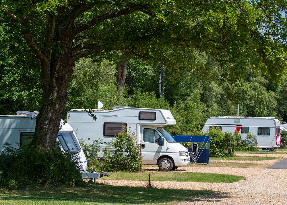 Caravans and tourers pitched up at Back of Beyond Touring, Camping & Glamping Park.