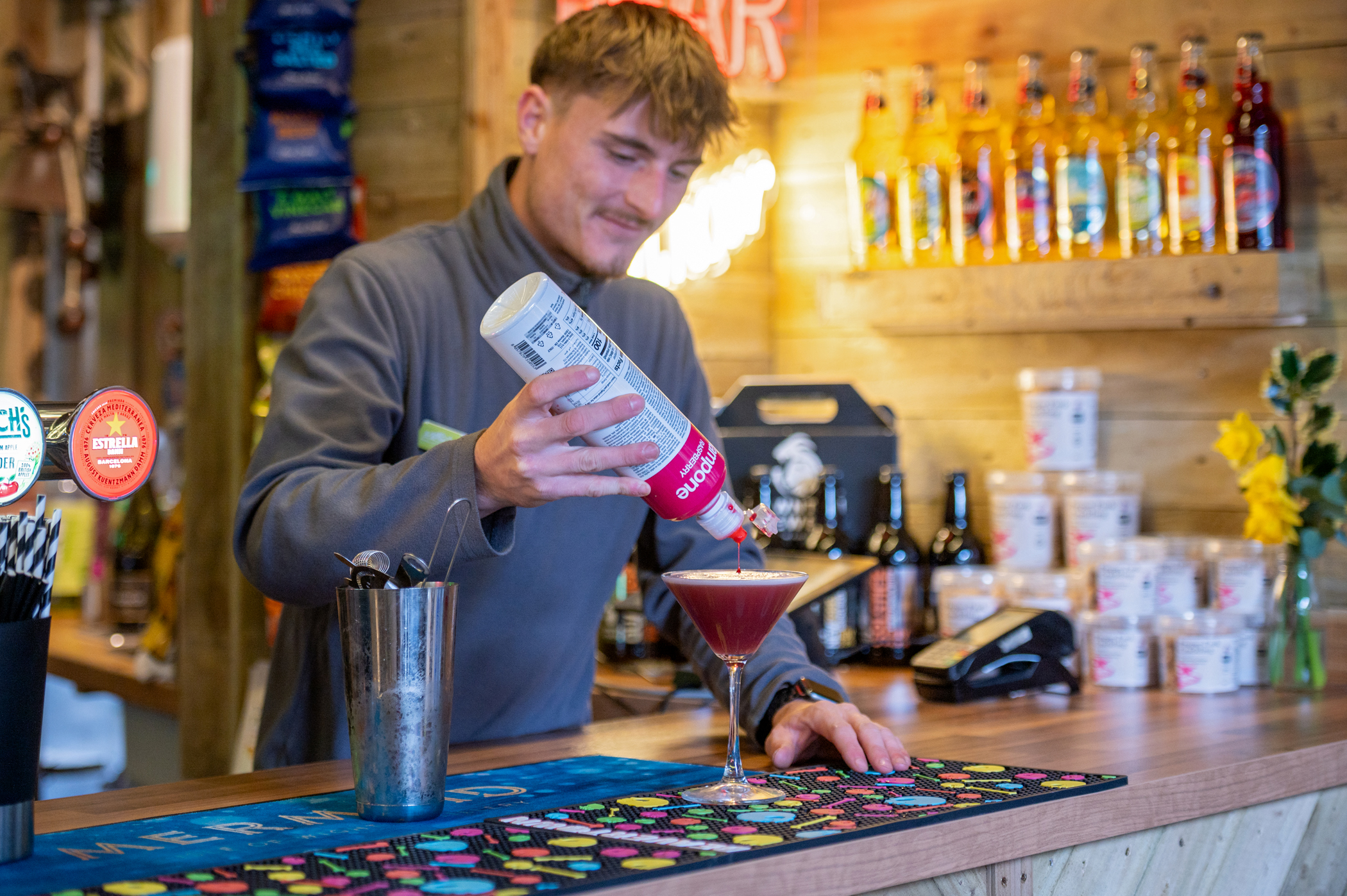 Mixologist, Sam pours a cocktail at Monty's Bar