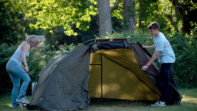 Two people pitch up a tent in Damson
