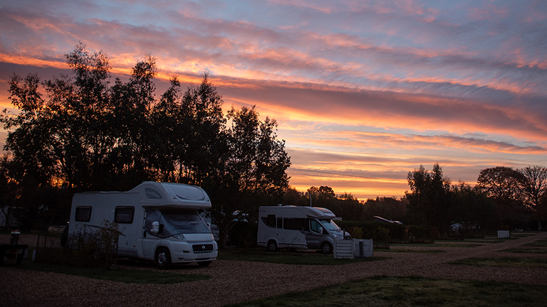 Caravans pitched on an autumn night at Back of Beyond.