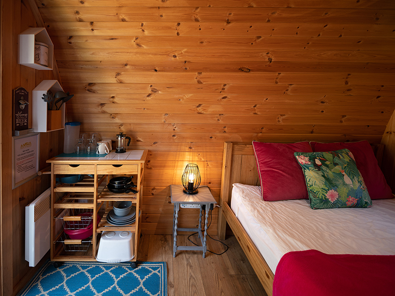Kitchenette and bed in Kingfisher glamping pod