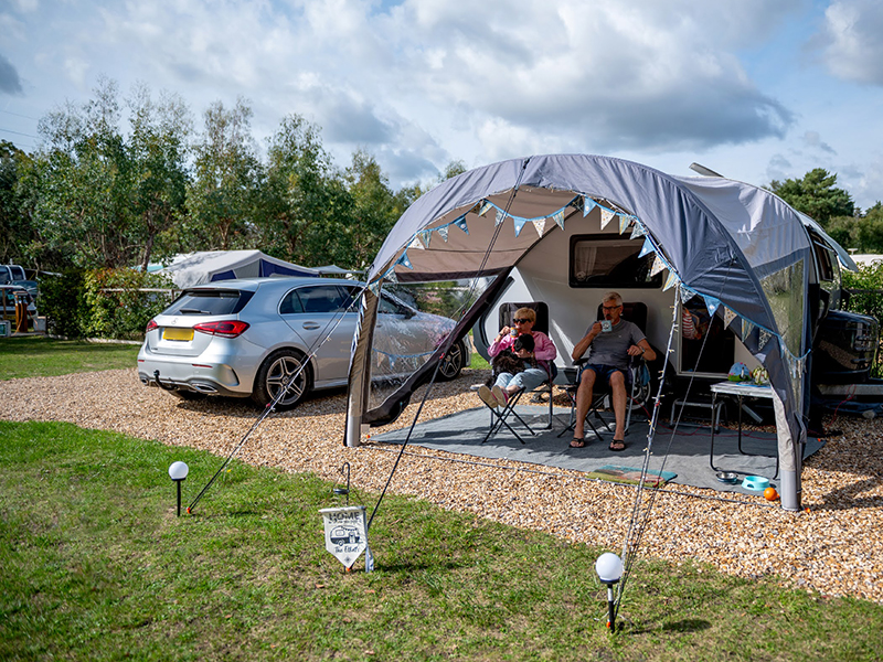 Standard hardstanding pitch with caravan, awning and car