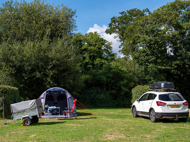 Tent, trailer and car on a pitch in Damson