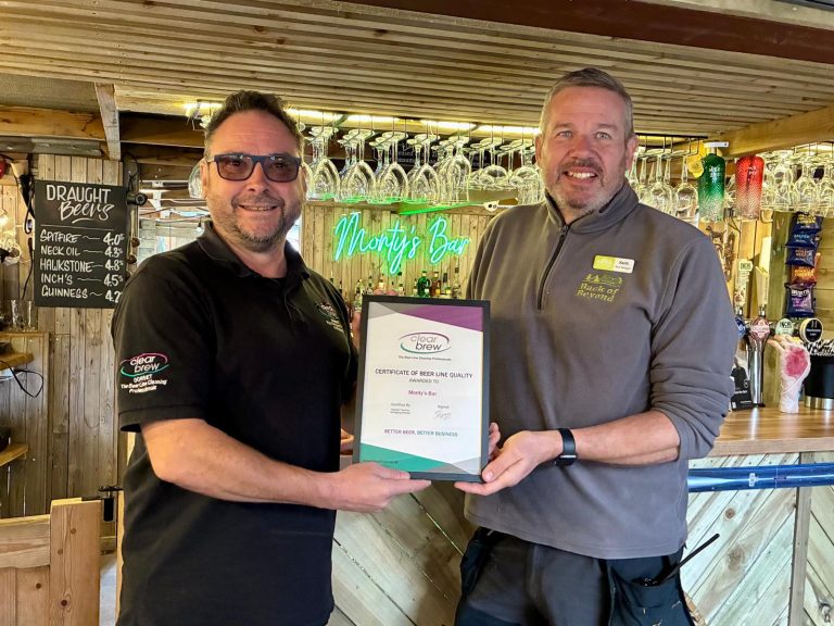 Keith from Back of Beyond poses with a certificate from Clear Brew at Monty's Bar