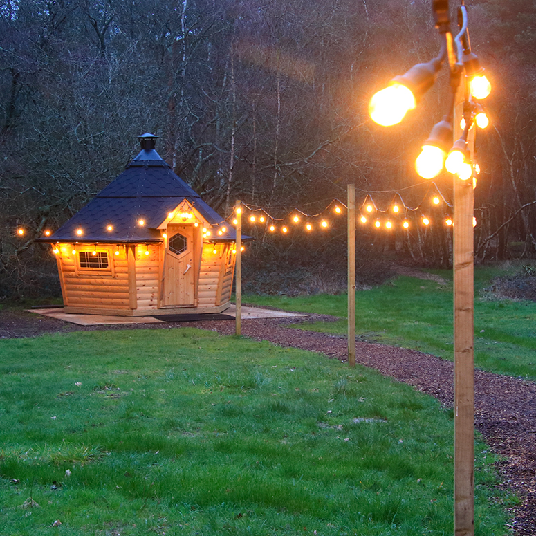 The exterior of the Hideaway at dusk - showing illuminated festoon lights