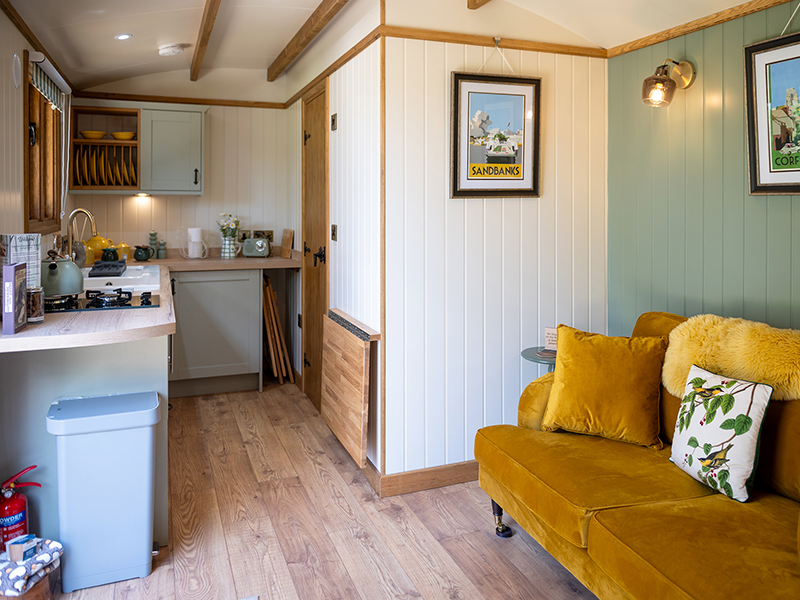 The living room and kitchen area of Heather, ensuite shepherd hut