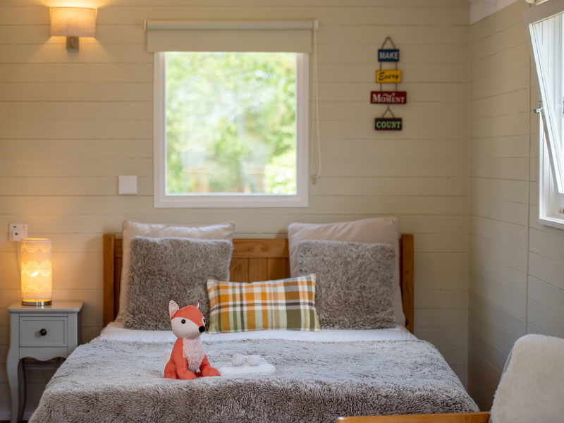 A bed and the interior of Foxglove shepherd hut