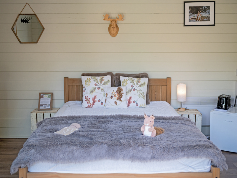 Double bed and furnishings inside Squirrel lodge
