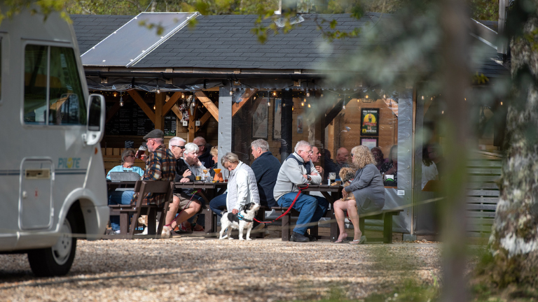 People and their dogs sit at Monty's Bar