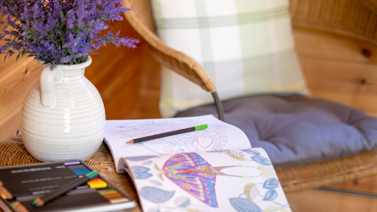Colouring and pencils on a table in a glamping pod